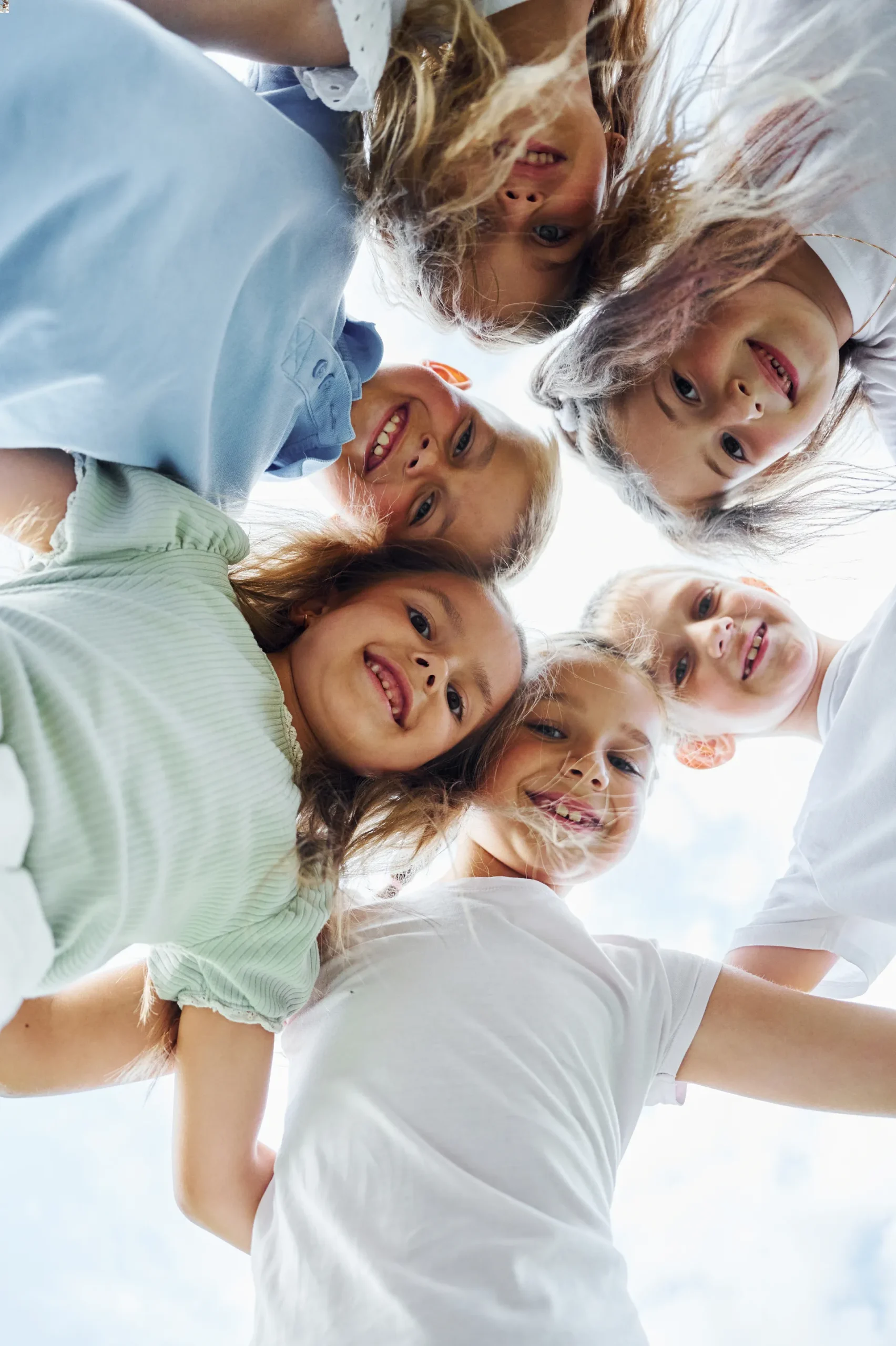 view-from-below-of-happy-kids-that-are-standing-to-2023-11-27-04-51-43-utc